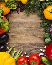 Top view vegetables assortment with wooden background