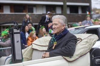 Actor Patrick Duffy sits in an old style carwaiting to be driven through the centre of Dublin for the St Patrick's day parade. Dublin