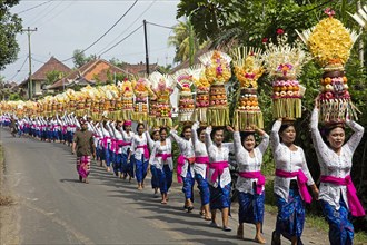 Procession of traditionally dressed women carrying temple offerings