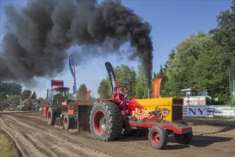 Modified diesel tractor pulling heavy sled at Trekkertrek