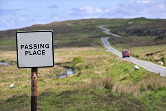 Traffic sign along single track road with passing places on the the Isle of Skye