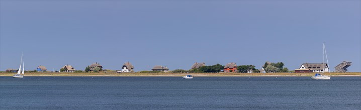 Sailing boats and beach houses along the Baltic Sea on the peninsula Graswarder