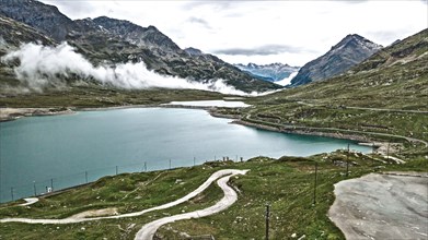 Photo with reduced dynamics saturation HDR of mountain lake at mountain pass alpine mountain road alpine road pass road Bernina Pass Bernina Pass