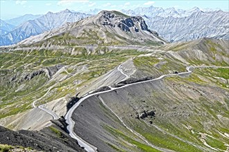 Photo with reduced dynamic saturation HDR of mountain pass alpine mountain road alpine road pass road pass view from viewpoint Cime de la Bonette on Col de la Bonette in French Alps High Alps in high ...