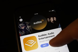 Detailed view of a smartphone with Audible app in the iPhone App Store