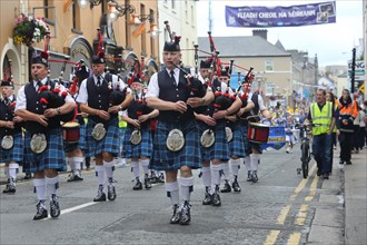An Irish pipe band marches at the head of the final parade to mark the end of Fleadh Cheoil na hEireann