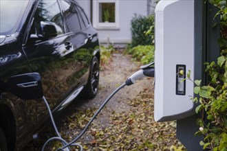 An e-car being charged at a private charging station