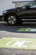 An e-car charges at a public charging station in Duesseldorf