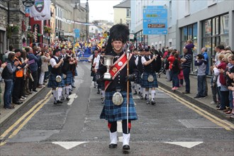 An Irish pipe band marches at the head of the final parade to mark the closing of Fleadh Cheoil na hEireann