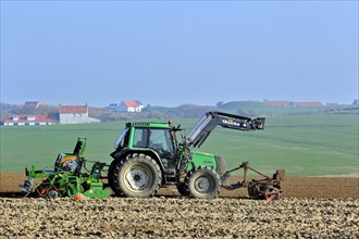 Tractor sowing seeds with seed drill