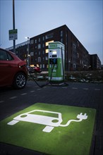 An e-car charges at a public charging station in Duesseldorf