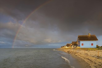 Rainbow and beach houses on the peninsula Graswarder