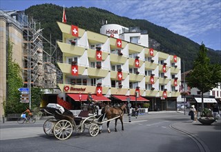 Horse-drawn carriage Hotel Bernerhof Swiss flags