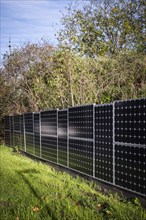 Solar panels as a garden fence and privacy screen of a house on a street in Langenfeld