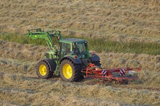 Tractor with rotary hay rake