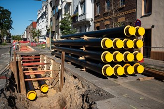 A stack of new pipes for district heating at a construction site in Duesseldorf