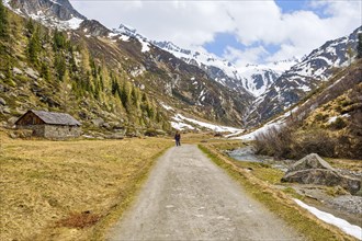 Hiker next to alpine hut in Ahrntal