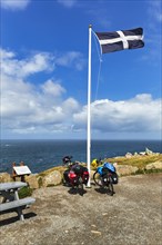 Two e-bikes under the Cornwall flag