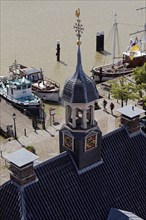 Ships in the museum harbour with the tower of the Alte Waage seen from the town hall tower
