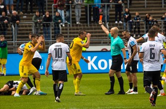 Referee Nicolas Winter shows the red card to player Luca KERBER left