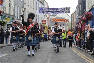 An Irish pipe band marches at the head of the final parade to mark the close of Fleadh Cheoil na hEireann