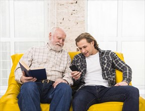 Father son browsing information cell phone