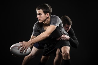 Front view male rugby players with ball