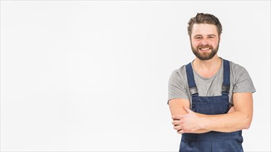 Man overall smiling with crossed arms