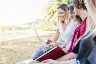 Friends studying outside with laptop