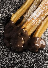 High view churros with sugar chocolate