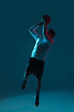 Man playing basketball with cool lights