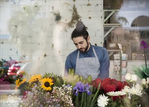 Portrait male florist standing colorful flowers flower shop
