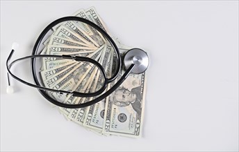 Medical stethoscope on twenty dollar bills isolated