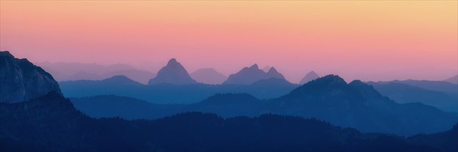 Panorama hilly landscape with mountains Kleiner and Grosser Mythen after sunset