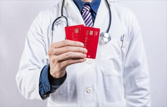 Doctor hands holding credit cards. Doctor holding two credit card isolated. Concept of medical card payments
