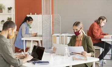 Co workers wearing face mask work