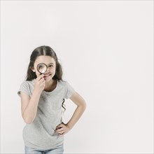 Girl standing studio with loupe