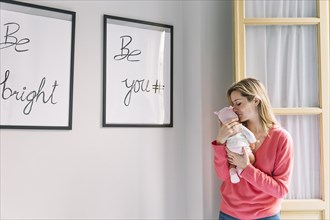 Woman holding baby frames with quotes