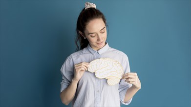 Front view woman holding paper brain