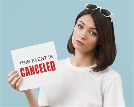 Woman holding card with canceled event message