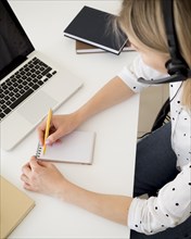 High view woman writing notepad