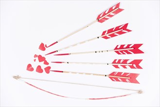 Love arrows aiming small red hearts