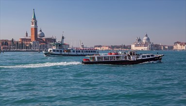 Boat traffic on the lagoon with the island of San Giorgio and the church of Santa Maria della Salute