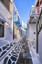 Charming traditional narrow streets and beautiful alleyways of Greek island towns. Whitewashed houses