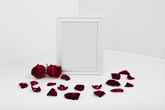 Frame with red roses white table