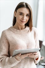 Portrait young businesswoman with tablet