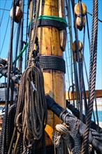 Mast of old wooden Age of sail sailing ship with ropes cordage and shroud