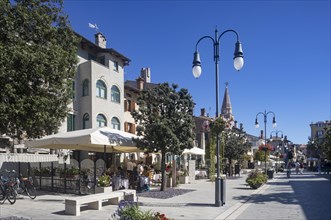 Pedestrian zone with restaurants in the old town of Grado