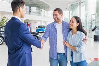 Car dealer talking clients