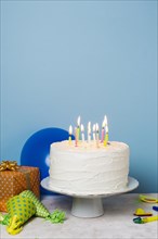 Lit candles birthday cake